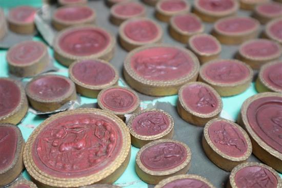 Three trays of 19th century Italian Grand Tour plaster cameos and intaglios